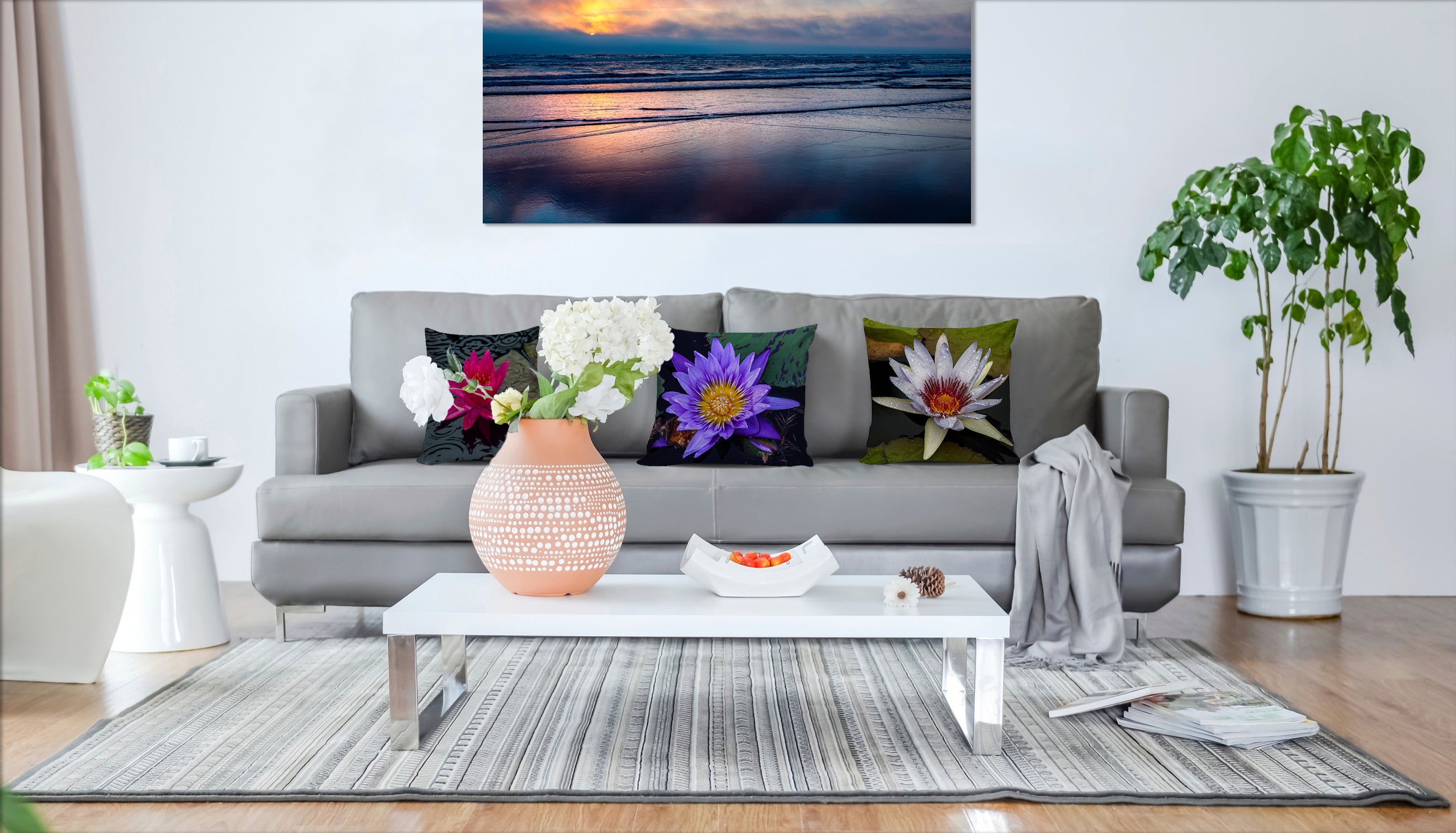 SHot of a living room couch with three pillows all featuring water lilies.